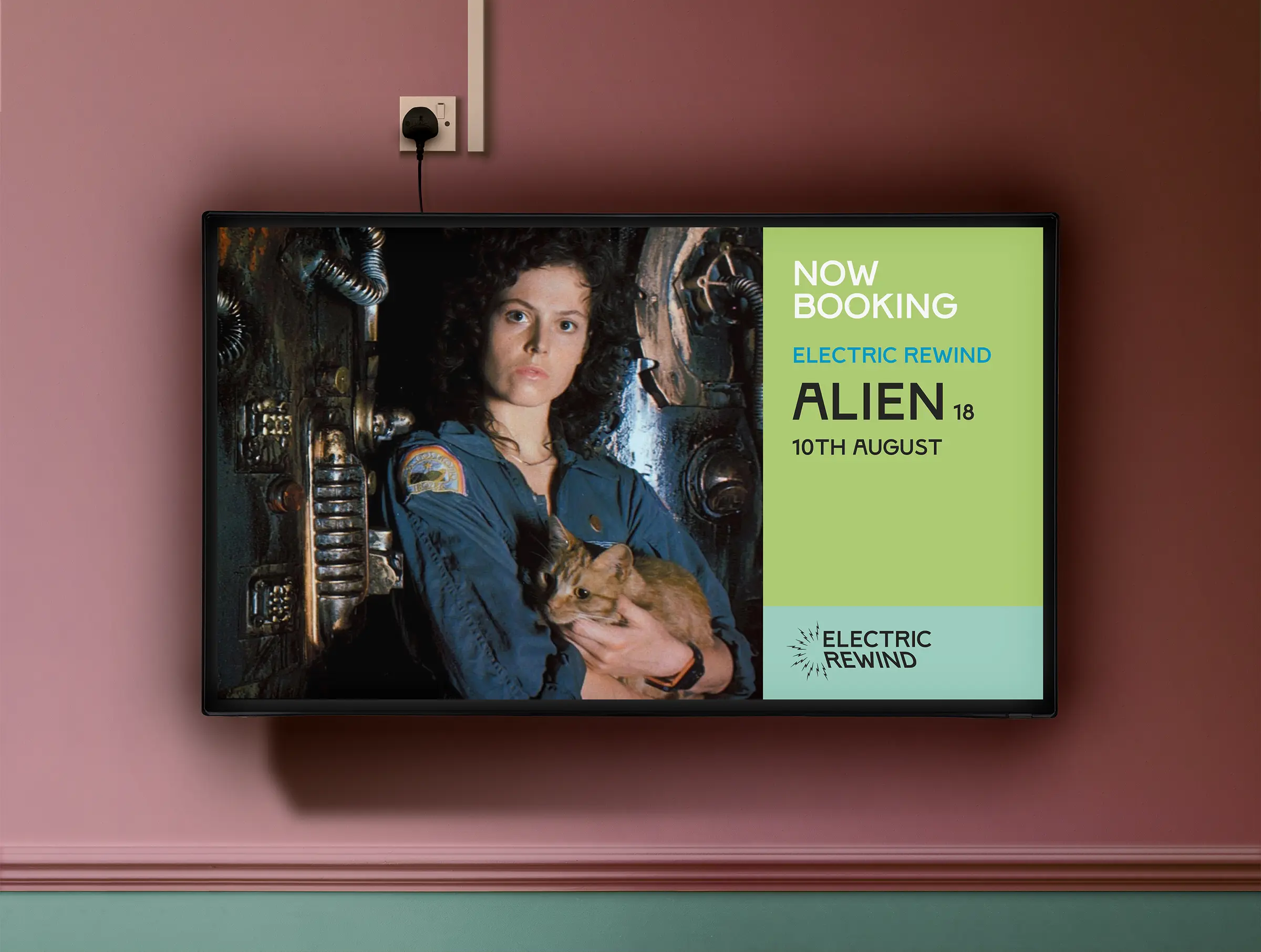 An image of a TV screen against a pale pink wall in the foyer of The Electric. An image of a woman in overalls holding a cat covers the left 2/3 of the screen, with a coloured panel on the right and text reading 'Now Booking, Electric Rewind, Alien (18), 10th August.
