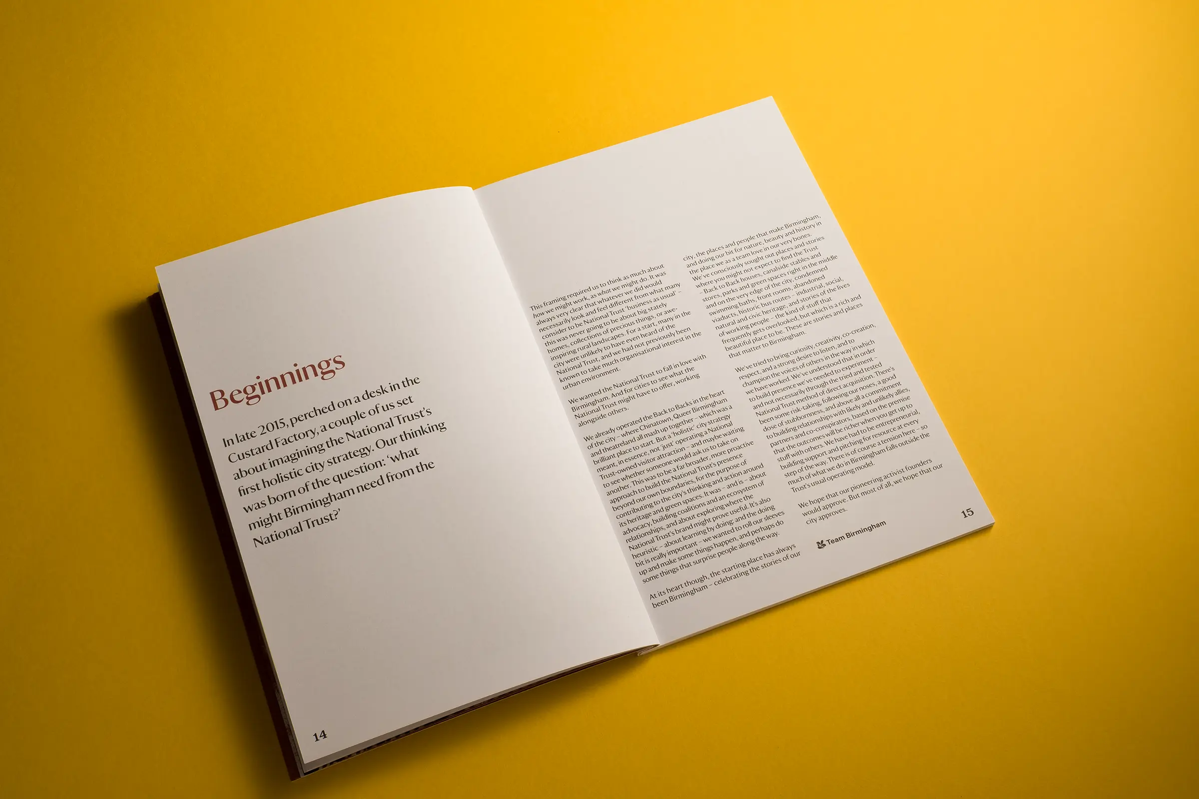 An image of a white brochure for National Trust Birmingham, lying on a bright yellow background
